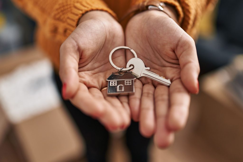 House keys inside woman's cupped hands.